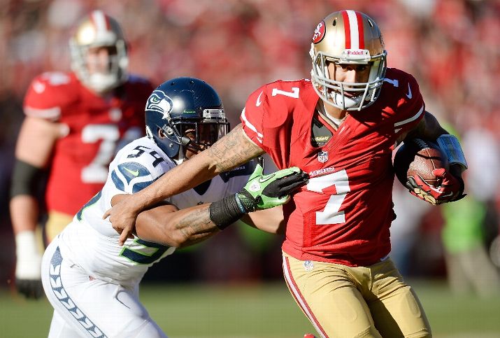SAN FRANCISCO, CA - DECEMBER 08: Colin Kaepernick #7 of the San Francisco 49ers scrambling with the ball gets grabbed by his jersey from Bobby Wagner #54 of the Seattle Seahawks during the first quarter at Candlestick Park on December 8, 2013 in San Francisco, California. (Photo by Thearon W. Henderson/Getty Images)