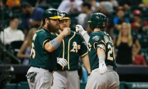 HOUSTON, TX - APRIL 25: Derek Norris #36 and Josh Donaldson #20 of the Oakland Athletics celebrate after Donaldson hit a two-run home run in the ninth inning of their game against the Houston Astros at Minute Maid Park on April 25, 2014 in Houston, Texas. (Photo by Scott Halleran/Getty Images)