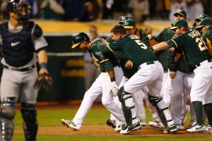 Oakland Athletics center fielder Coco Crisp is congratulated after hitting a walk off home run during the twelfth inning of a baseball game against the Seattle Mariners, Thursday, April 3, 2014, in Oakland, Calif. (AP Photo/Beck Diefenbach)