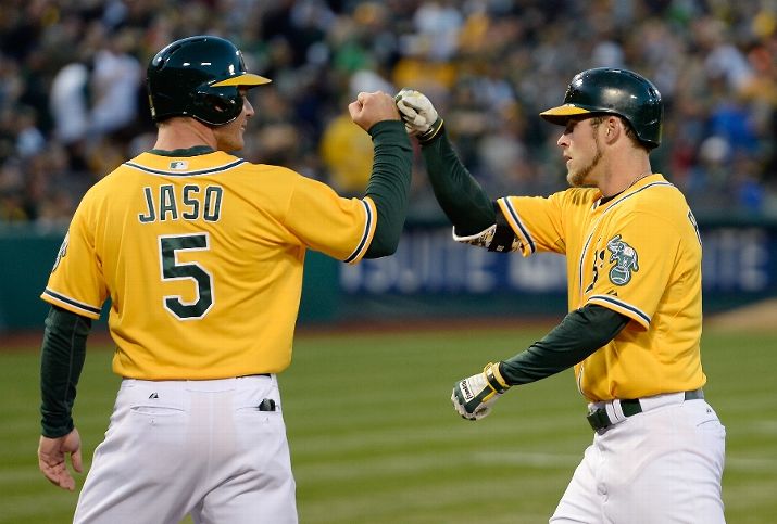 OAKLAND, CA - APRIL 18: Josh Reddick #16 of the Oakland Athletics is congratulated by John Jaso #5 after Reddick hit a two-run homer in the bottom of the first inning against the Houston Astros at O.co Coliseum on April 18, 2014 in Oakland, California. (Photo by Thearon W. Henderson/Getty Images)