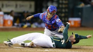 Texas Rangers catcher Robinson Chirinos tags out Oakland Athletics' John Jaso in the second inning of a baseball game Tuesday, April 22, 2014, in Oakland, Calif. Jaso was attempting to score on a fly ball by Jed Lowrie. (AP Photo/Ben Margot)