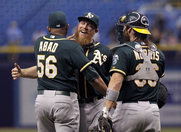 ST. PETERSBURG, FL - MAY 21: Pitcher Sean Doolittle (C) of the Oakland Athletics celebrates his save with teammates Fernando Abad #56 of the Oakland Athletics and catcher Derek Norris #36 of the Oakland Athletics after striking out Wil Myers of the Tampa Bay Rays to end the ninth inning of a game on May 21, 2014 at Tropicana Field in St. Petersburg, Florida. (Photo by Brian Blanco/Getty Images)