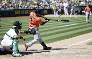 Houston Astros' Gregorio Petit (3) drives in a run with a single during the seventh inning of a baseball game against the Oakland Athletics, Sunday, Sept. 7, 2014, in Oakland, Calif. (AP Photo/Marcio Jose Sanchez)