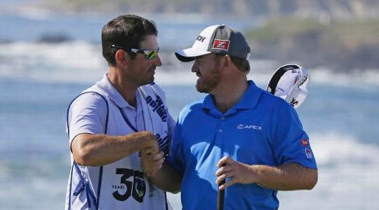 J.B Holmes is congratulated by his caddie at Pebble Beach.