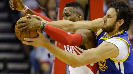 Houston Rockets center Dwight Howard, left, and Golden State Warriors center Andrew Bogut, right, go after a rebound during the first half in Game 3 of the NBA basketball Western Conference finals Saturday, May 23, 2015, in Houston. AP Photo/David J. Phillip