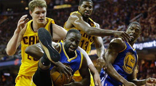 Golden State Warriors and Cleveland Cavaliers players battle for a rebound