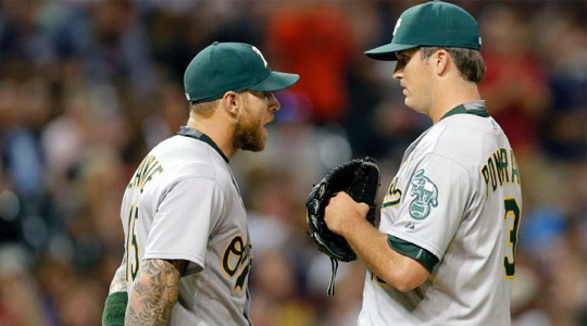 A's third baseman Bret Lawrie talks with A's starter Kendall Graveman