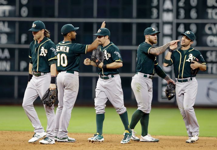 The Oakland Athletics celebrate their 4-3 win over the Houston Astros in a baseball game Friday, Sept. 18, 2015, in Houston. (AP Photo/Pat Sullivan)