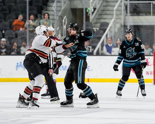 A fight at center ice between Tucson Roadrunners' Montana Onyebuchi and San Jose Barracuda's Scott Sabourin during the first period at Tech CU Arena on Friday FEB 7, 2025. (San Jose Barracuda)